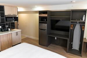 a room with a kitchen with a large microwave at Skye Hotel Ridgetown in Ridgetown