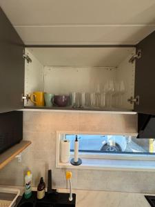 a kitchen with a counter with glasses on the shelf at The Container House in Fyresdal +31 photos