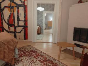 a living room with a fireplace and a television at Heritage House at Villa Sofia in Lahti