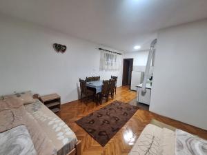 a room with a bed and a dining room with a table at Radnicki smestaj in Prilike