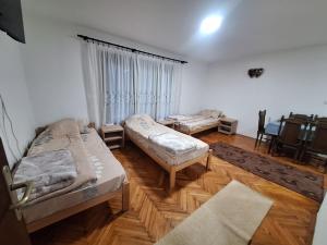 a room with two beds and a table in it at Radnicki smestaj in Prilike