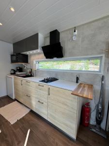 a kitchen with a stove and a window at The Container House in Fyresdal