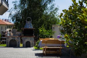 a patio with a fireplace and a bench and a grill at Villa Manevi in Yavornitsa +95 photos