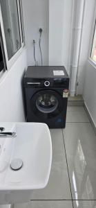 a washing machine sitting in a corner of a room at Lucy Residences in Ernakulam