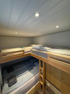 a room with two bunk beds in a boat at The Container House in Fyresdal