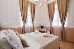 a bedroom with a bed with two towels on it at Aphrodite luxury rooms in Mytilene +37 photos