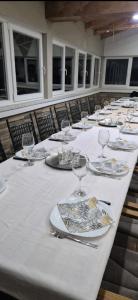 a long table with plates and wine glasses on it at Vikendica Avram-Plane in Plane +39 photos