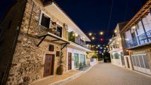 an empty street in a town at night at Markella STONE & LIGHT Skoutari-Mani in Skoutari