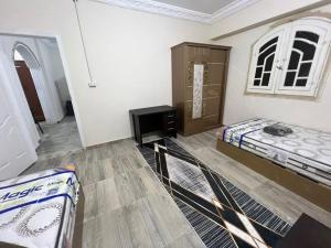a room with two beds and a dresser in it at Safa A house in Sintrīs