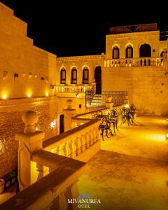 a building with lights on the side of it at night at MivanUrfa Otel in Urfa +64 photos