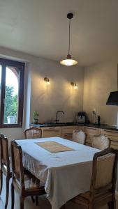 a kitchen with a table with chairs and a sink at Château Foncine in Foncine-le-Bas