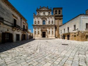 an old building with a clock tower in a courtyard at Tradomari in Mesagne