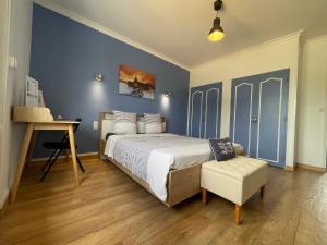 a bedroom with a bed and a table and a chair at Chez Tib in Trégunc