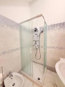 a shower in a bathroom with a toilet and a sink at Via Acquedotto 54 in Olbia +24 photos