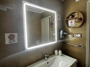 a bathroom with a sink and a mirror at Casa Pepe in Ourense +9 photos