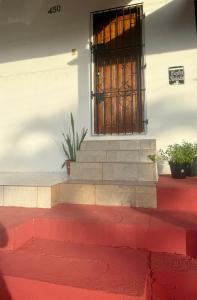 a building with a window and red stairs at Casa Fronteira in Oiapoque