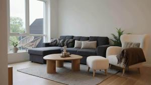 a living room with a blue couch and a table at The Haven II - Cozy 2BR Voss - The Voss Collection in Vossevangen