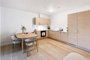 a kitchen and dining room with a table and chairs at The Haven II - Cozy 2BR Voss - The Voss Collection in Vossevangen