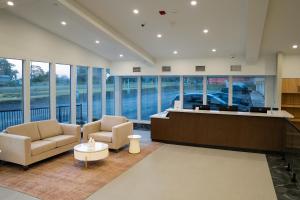 a lobby with two chairs and a reception desk at Skye Hotel Ridgetown in Ridgetown