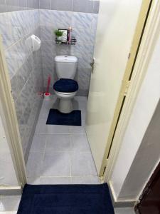 a small bathroom with a toilet in a stall at Tulia Retreats in Syokimau