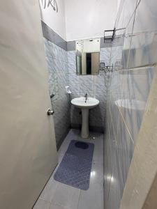 a bathroom with a sink and a toilet and a mirror at Tulia Retreats in Syokimau
