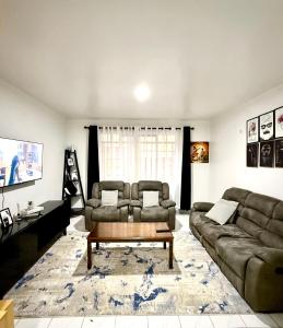 a living room with a couch and a coffee table at Tulia Retreats in Syokimau
