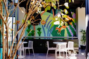 a wall mural in a restaurant with tables and chairs at Hm Express in Colima