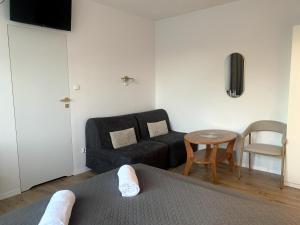 a living room with a couch and a table at Na Rogu in Sandomierz