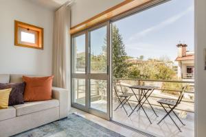 a living room with a couch and a balcony at Cinfães Centro Stay in Cinfães