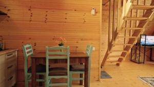 a dining room with a wooden table and chairs at Kesane Cottages in Racha in Oni