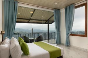 a bedroom with a bed and a balcony at Sunset Heaven Boutique in Kandy