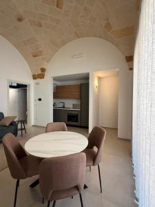 a living room with a white table and chairs at Tradomari in Mesagne