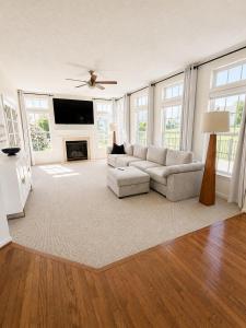 a living room with a couch and a fireplace at 4BR Home with Private Cinema in West Henrietta