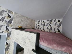 a bedroom with a bed and a fireplace at Apartament DARIS in Wałbrzych