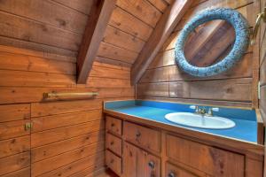 a bathroom with a sink and a mirror at Oscars Outpost Fire Pit Pet Friendly in Mineral Bluff +26 photos