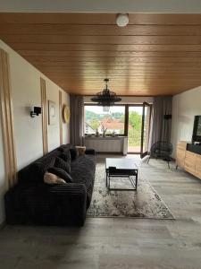 a living room with a couch and a table at Haus am Skywalk 3L in Beverungen