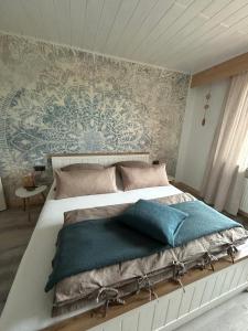 a bedroom with a large bed with blue pillows at Haus am Skywalk 3L in Beverungen