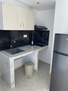 a kitchen with a sink and a refrigerator at Georgia's House Olympiada in Olympiada