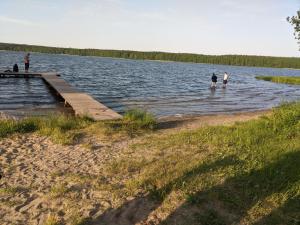 a group of people standing on a dock in a lake at Czerpak in Małszewko