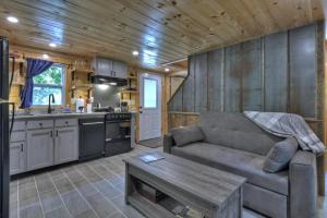 a living room with a couch and a table in a kitchen at Ocoee Cottage Water Front in Copperhill