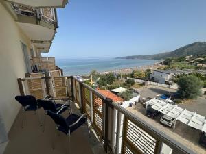 a balcony with chairs and a view of the ocean at Hotel e Residence Il Faro Acciaroli in Acciaroli