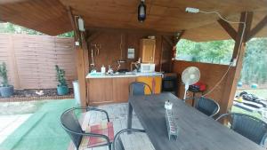 a table and chairs in an rv with a kitchen at Zitanka Apartman Bogács in Bogács
