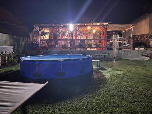 a large blue tub in a yard at night at Zitanka Apartman Bogács in Bogács