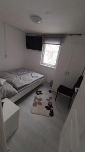 a bedroom with a bed and a rug with cows on it at Zitanka Apartman Bogács in Bogács +17 photos