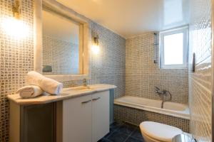 a bathroom with a sink and a tub and a toilet at Dolphins maisonette Rhodes in Ialysos +21 photos