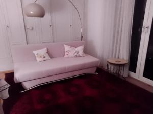 a living room with a white couch with pillows at taunus in Königstein im Taunus