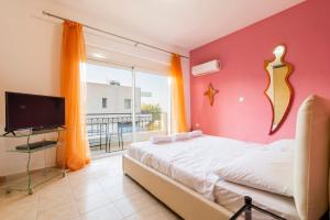 a bedroom with a bed and a large window at Dolphins maisonette Rhodes in Ialysos