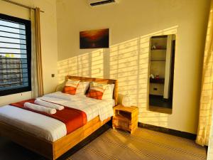 a bedroom with a bed and a large window at Shubbys Villa in Dar es Salaam +39 photos