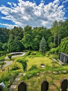 a view of a garden with trees in the background at Slunečná Chalet in Velké Chvojno