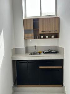 a kitchen with a sink and a counter top at Galápagos Downtown Suite in Puerto Ayora +4 photos